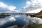 Norwegian old city Reine with reflections in water and cloudy sk