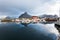 Norwegian old city Reine with reflections in water and cloudy sk