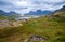 Norwegian panorama of green hills, mountains on the horizon, lakes and fjords. View from above from the cliffs on the airy