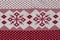 Norwegian Pattern Of Red And White Yarn. Fair Isle Ornament At Cozy Knitted Cloth. Wallpaper. Yarn Knitted Background