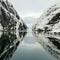 Norwegian sailing trollfjord and coast during a winter sail with snow