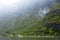 Norwegian village in Fjord with waterfalls in the background