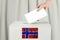 Norwegian Vote concept. Voter hand holding ballot paper for election vote on polling station