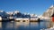 Norwegian winter lansdcape with the red rorbu and fishing ships