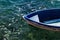 Nos white blue small wooden fishing boats standing at the pier in clear water