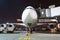 Nose and cockpit airplane gangway of the terminal building at the airport at night, aircraft flight maintenance.