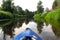 Nose of a kayak at water level in a calm countryside river