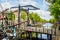 The nose of an old tjalk and a drawbridge across a canal in Schiedam, Netherlands.