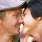 Nose touch, love and happy couple together outdoor, healthy relationship and connection in summer. Man, woman and