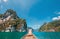 Nose of wooden motorboat view, vessel sailing on Thai Khao Sok Lake with foresty mountains around