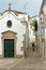 Nossa Senhora da Piedade Church, located along a typical cobbled narrow street inside the old town of Tavira, Algarve