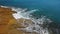 Nostalgic aerial video, in slow motion of the sea, the waves smoothly roll on the rocky shores of the Pacific Atlantic