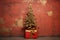 Nostalgic Christmas Scene: Red Gift Box and Gold Ribbon Adorned Tree against Aged Wall Backdrop.