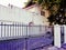 Nostalgic old purple white building behind a fence, Cape Town