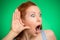 Nosy woman hand to ear gesture eavesdropping shocked