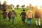 Not all who wander are lost. Rearview shot of a group of friends walking through a field together.