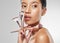 Not every artist uses a paintbrush. Studio shot of an attractive young woman holding a collection of makeup brushes