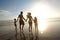 Not missing one moment of the sunset. Rearview shot of a young family walking on the beach at sunset.