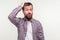 Not sure, don`t know! Portrait of confused bearded man in plaid shirt scratching head. isolated on white background