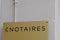 Notaire french text in golden french sign gold logo notary office building wall notaires means notaries agency