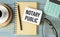 NOTARY PUBLIC is written in a white notepad near a calculator, coffee, glasses and a pen.