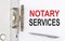 NOTARY SERVICES text on the paper folder with pen. Business concept