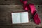 Note book, pen, red necktie on grungy wooden surface