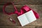 Note book, pen, red necktie on grungy wooden surface