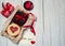 A note with a Declaration of love, a box of chocolate and cookies in the form of hearts, a candle and a decorative gift box on a l