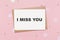 note letter with sparkles on pink background  love and valentine concept with text I miss you