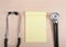 Note pad of yellow paper, blank, with stethoscope