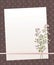 Note white paper on a dark brown background with vertical and horizontal stripes and round circles pink mother-of-pearl line bow w