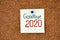 Note with words Goodbye 2020 on corkboard