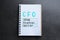 Notebook with abbreviation CFO Chief Financial Officer on grey stone background, top view
