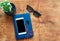 Notebook, cellphone, headphones and black glasses on wooden desk. Flat lay, copy space, mock up