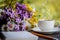 Notebook, flowers and cup of coffee on the desk