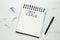 Notebook with inscription 2021 Goals, new year aims. Objects on white marble table, flat lay