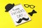 Notebook with inscription happy fathers day, decorative bow tie, glasses, mustache and hat on color background