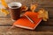 Notebook, knitted sweater with autumn leaves and coffee mug