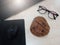 Notebook ,mouse pad , mouse,glasses and reisins bread placed on