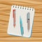 Notebook, orange pen, blue pen and brown pen