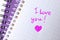 Notebook page with written words I LOVE YOU and heart