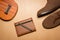 Notebook, pen , ukulele and boots on a brown paper background