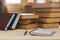 Notebook with pen on a wooden table in front of the window. Horizontal frame.