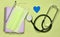 Notebook, pencil, stethoscope, decorative heart on a blue background. Medical equipment.