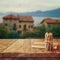 Notebook and pencils on old wooden table in front of romantic Provence rural landscape. retro filtered image