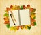 Notebook and pens on dry autumn leaves