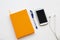 Notebook planner with mobile phone for business work arrangement flat lay style