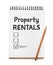 Notebook with Property Rentals, check mark and boxes on white background