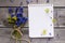 Notebook, spring flowers on wooden background
